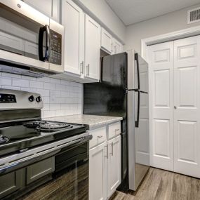 Upgraded Units Available with Sleek Black Appliances, Vinyl Plank Wood Flooring, Ceramic Tile Backsplash and Granite Like Countertops at The Edge of Germantown Apartments Home