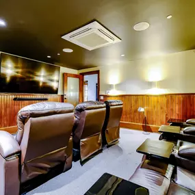 Theater Room with Recliner Seating and Large Screen TV