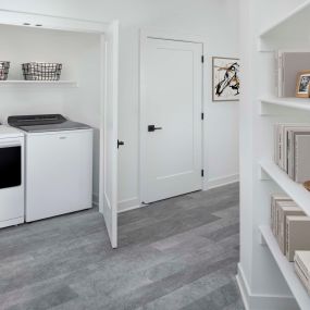 Full-size washer and dryer and built-in shelving at Camden Durham Apartments in Durham, NC
