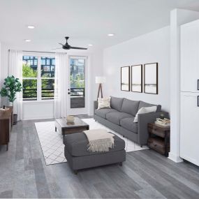 Spacious living room with private balcony and wood-style flooring at Camden Durham apartments in Durham, NC