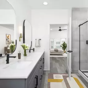 Townhome primary bathroom with double sink vanity and standing shower at Camden Durham apartments in Durham, NC