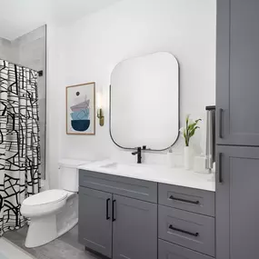 Townhome bath with large bathtub, curved shower rod, and tile surround