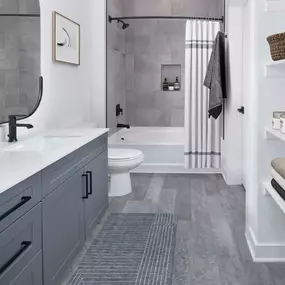 Bathroom with bathtub and shelving at Camden Durham Apartments in Durham, NC