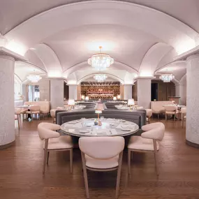 Dining area of Druise & Darr with high ceilings & light decor