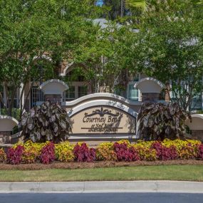 Lush landscaping surrounds you as you drive into Courtney Bend Apartment Homes