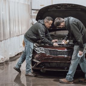 Collision Leaders vehicle experts inspecting a vehicle before returning it to the customer.