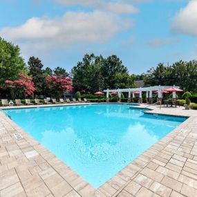 Refreshing Swimming Pool with Relaxing Poolside Lounge Chairs at Lake Cameron Apartment Homes