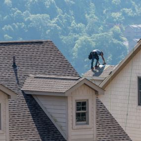 Carpenter installing roofing with Manor Roofing services