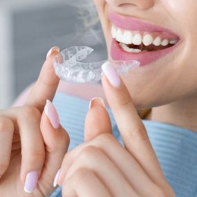 Clear aligners, often referred to as invisible aligners, are a type of treatment that corrects misaligned or crooked teeth to help create a perfect smile. Clear aligners gradually adjust the position of your teeth over time, just like traditional metal braces, while being practically invisible on your teeth.