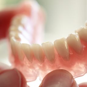 Dentures are removable false teeth, and getting them is an easy procedure and a fast, reliable solution if you’re missing any teeth. Complete dentures are made of a pink resin designed to look like gums and natural-looking teeth.