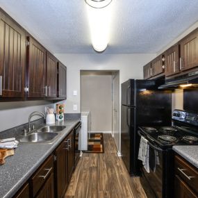 Gourmet Kitchens with G.E. Black Appliances and Maple Raised-Panel Cabinetry at Addison on Cobblestone Apartment Homes