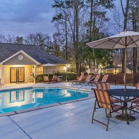 Enjoy Our Pool Deck with Patio and Chairs at Addison on Cobblestone Apartment Homes