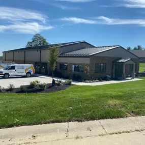 Exterior of Call Now Heating & Cooling’s office building in Independence, KY, with two branded company vans parked out front. The building has a clean, professional appearance, representing the company’s physical location.