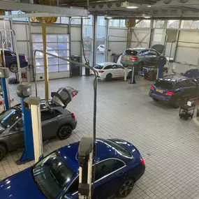 Cars inside the Mercedes Ben of Ayr service centre workshop