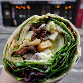 Underworld: Grilled Steak wrapped in orginal white flour dough with granny smith apples, pickles, toasted cashew nuts, goat cheese and white sesame sauce
