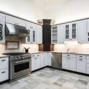 Bray & Scarff kitchen showroom in Frederick, MD with white cabinets, steel appliances, and gray tile floors