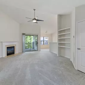 living room with a fireplace and a ceiling fan