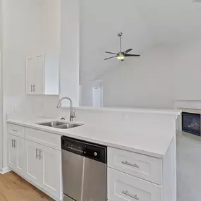 kitchen with white cabinets and a sink and a ceiling fan
