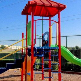 Playground with slide surrounded by a mulch bottom.