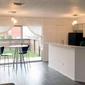 Spacious living room with sliding glass door to outdoor patio.