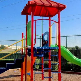 Playground with slide surrounded by a mulch bottom.