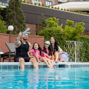 Family of four plays together at the outdoor pool at Little America Hotel in Salt Lake City.