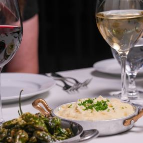 Blistered Shishito Peppers and Boursin Cheese Whipped Potatoes.