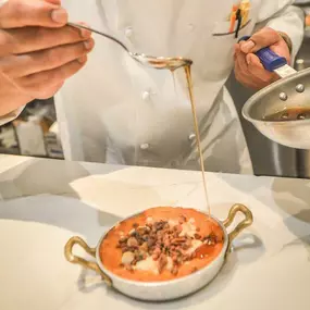 Chef Preparing Whipped Praline Sweet Potatoes with candied pecans and streusel crisp on top