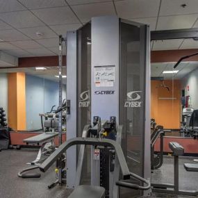Fitness center featuring cardio equipment and free weights