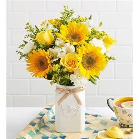 Get them buzzing for summer! Our unique, stylized bouquet is gathered with a mix of blooms in bright, happy yellow & white. Designed in our Sweet As Can Bee artisanal vase, featuring an adorable honey bee and raffia bow, it’s a gift that adds radiant beauty to any decor.