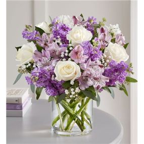 Lovely memories are made with thoughtful gifts for the ones we care about. Our charming bouquet is loosely gathered with a medley of lavender & white blooms. Hand-designed inside a clear cylinder vase with cascading greenery all around, it’s a wonderful way to express the sentiments you have inside your heart.