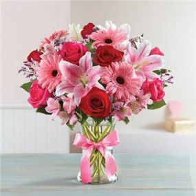 Inspired by the rich beauty of the European countryside, our romantic bouquet reveals all the feelings you have in your heart. Fresh-picked pink & red blooms are on display inside a glass vase finished with ribbon, creating a timeless gift for someone you love.