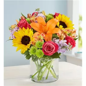 Like a warm embrace, our vibrant bouquet delivers your sentiments to someone special. A rich gathering of yellow and orange blooms, with pops of bright pink and purple, it's more than a gift - it's a way to express how you feel inside.