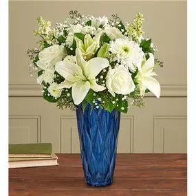 Send your wishes in elegant style. Our handcrafted arrangement is filled with a mix of soothing white blooms and lush greenery. Designed in our Blue Harmony vase, featuring striking color and exquisite texture, it’s a gift to wow the people you love.