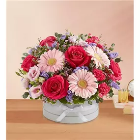 Celebrate your love with our enchanting bouquet. A perfectly pink mix of blooms is gathered in our signature dove gray European hatbox, adding to its elegance.