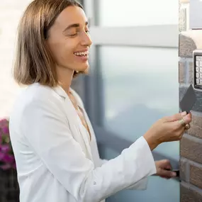 Woman entering an office highlights Michael's Keys Locksmith’s advanced access control solutions.