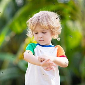 Toddler surrounded by mosquitoes