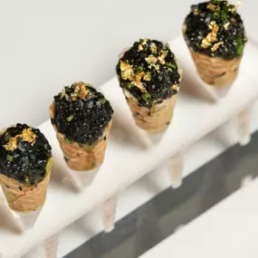 Siberian Osetra Caviar atop horseradish crème fraîche, crowned with gold leaf
