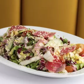 Chopped Napa Salad. Heirloom cherry tomatoes, radicchio, and toasted sesame seeds tossed in miso honey and white balsamic.
