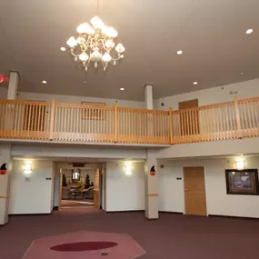 a large room with a balcony and a chandelier