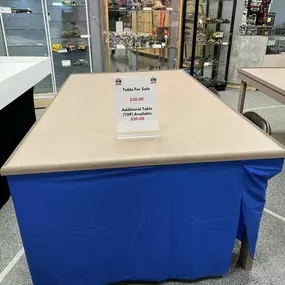 We have some tables and a table top available. Complete tables are $30 and the table top is $20. Dimensions are approximately 4 Ft. 2 In. Wide and 7Ft long.