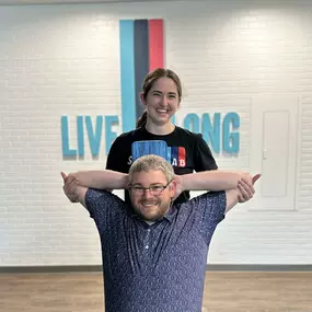 Alex is working with one of our members, Daniel! In this photo, she’s guiding him through a deep pec stretch.