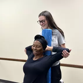 Madeleine doing a pec stretch at a pop-up event in Waco.
