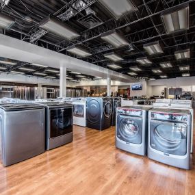 Appliance showroom with multiple laundry appliances on display