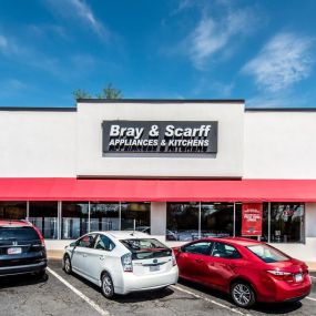 Outside view of the Bray & Scarff appliance store building in Arlington, VA with cars parked outside