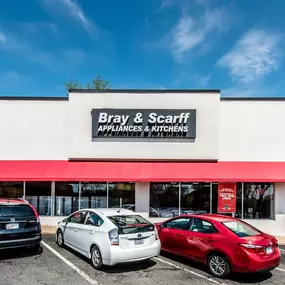 Outside view of the Bray & Scarff appliance store building in Arlington, VA with cars parked outside