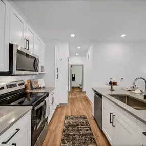 Kitchen with stainless steel appliances and white cabinets