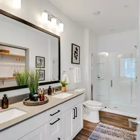 Bathroom with a large mirror and a toilet and a shower