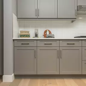 Small kitchen after cabinet painting in Cohasset