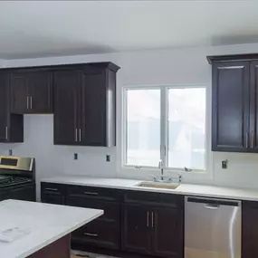 Kitchen with dark cabinets after cabinet painting in Duxbury